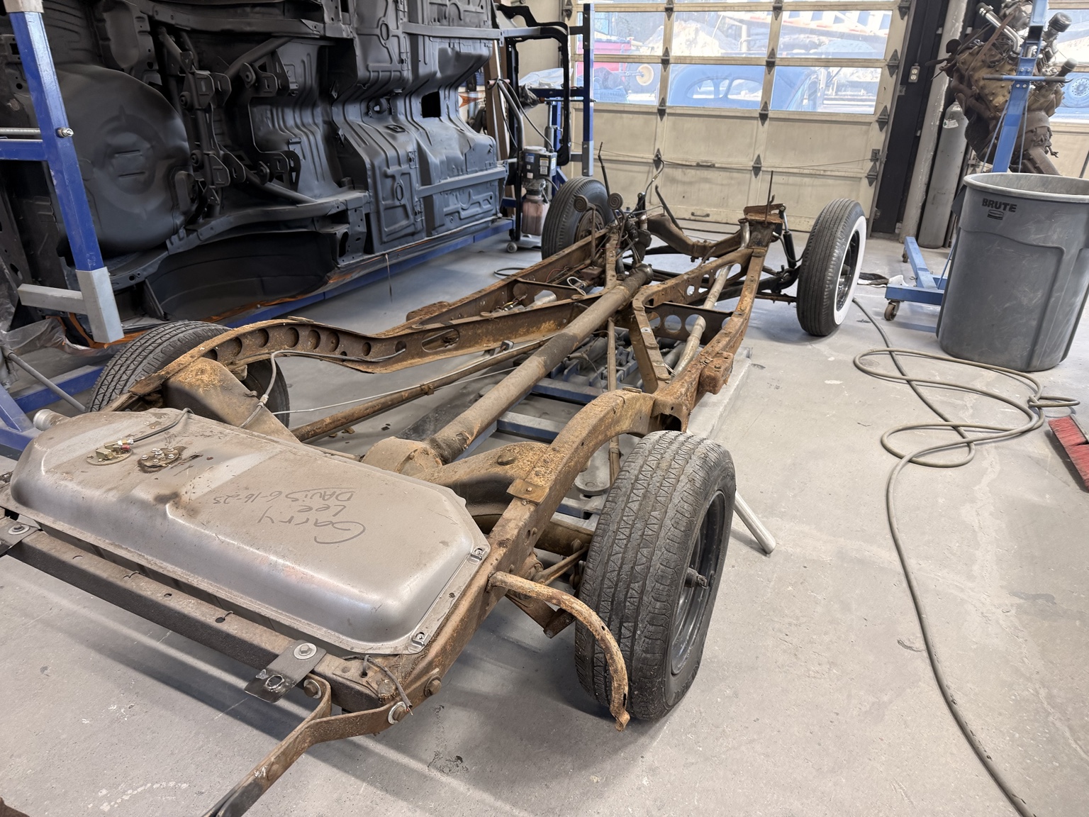 Original photo of stripped vehicle chassis and frame
